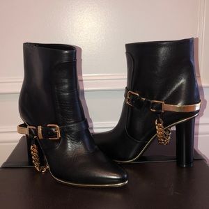 Balmain, leather ankle boots with gold accent.
